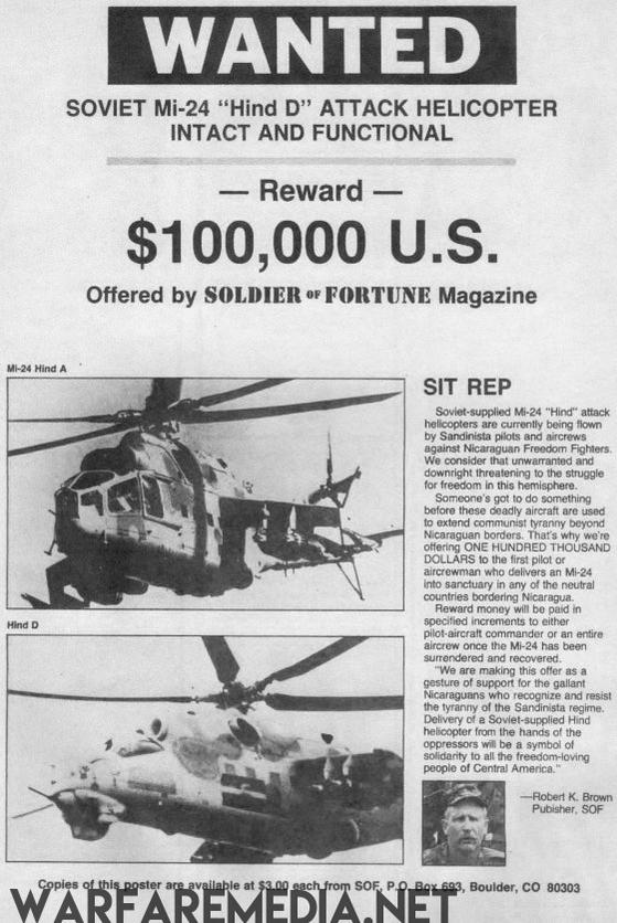 Warfare Media's SOF Mi24 Hind Wanted Poster features the Soviet Mi-24 Hind D attack helicopter on high-quality semi-glossy paper. Includes flight images, mission details, and offers a $100,000 reward. Offered by Soldier of Fortune Magazine with contact info at bottom.