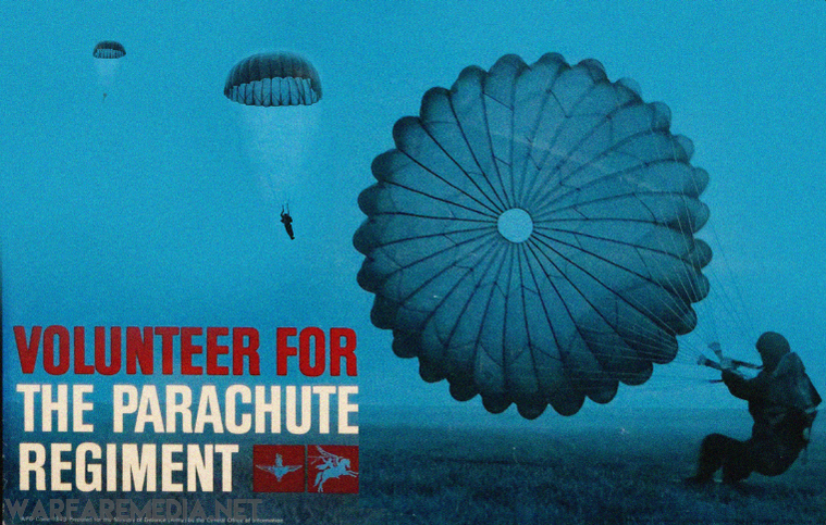 Three parachutists descend against a blue-tinted sky, with a large, fully extended parachute in the foreground. Bold text reads: "VOLUNTEER FOR THE PARACHUTE REGIMENT" in red and white letters. Two red insignias are displayed near the bottom right corner of these high-quality Parachute Regiment Recruitment Advert posters by Warfare Media, printed on FSC-certified paper.